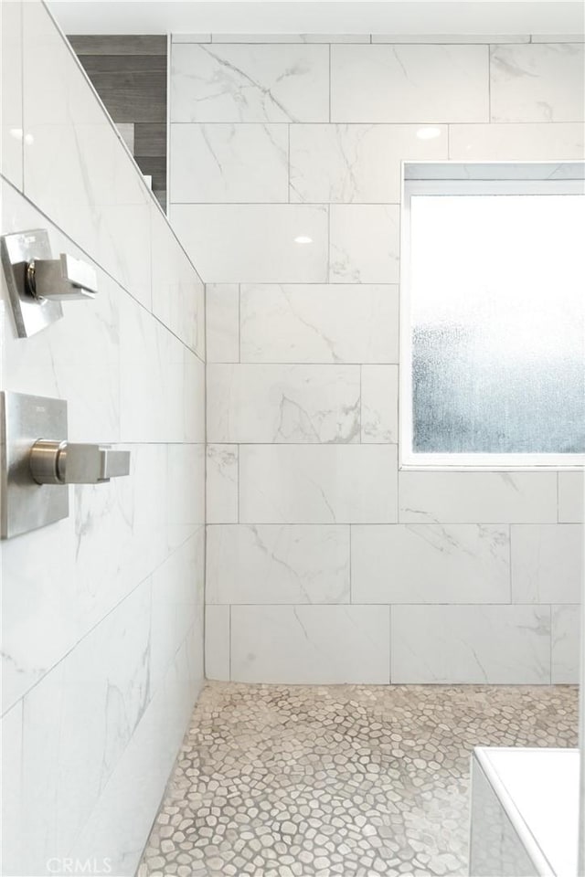 full bath featuring a tile shower