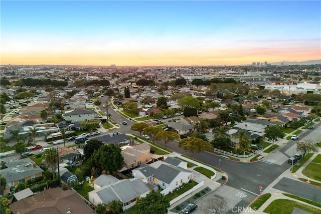 aerial view at dusk featuring a residential view