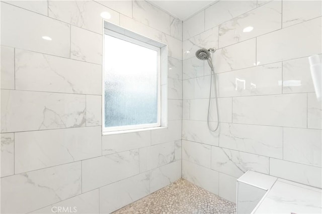 bathroom with tiled shower