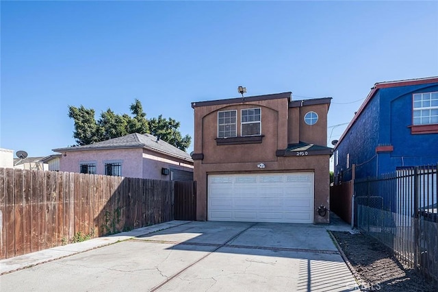 exterior space featuring driveway, a garage, fence, and stucco siding