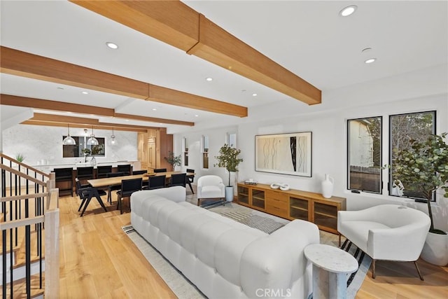 living room featuring recessed lighting, beam ceiling, and light wood finished floors