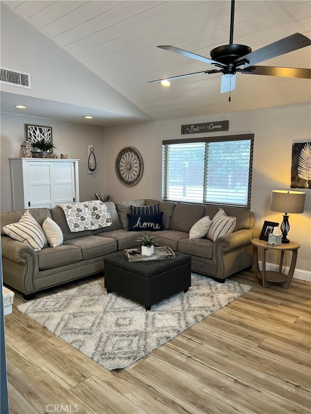 living room featuring lofted ceiling, recessed lighting, wood finished floors, visible vents, and a ceiling fan