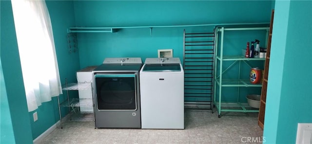 laundry room featuring laundry area, separate washer and dryer, and light floors