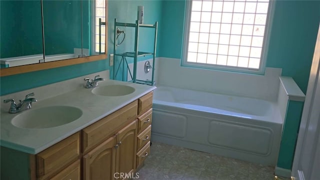 full bath with a garden tub, a sink, and double vanity