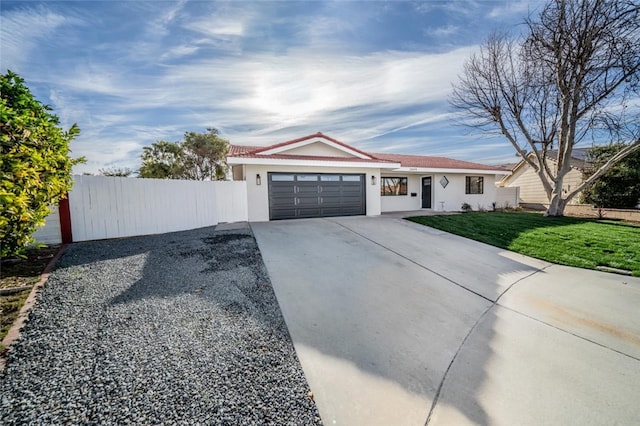 ranch-style house with a garage, fence, concrete driveway, stucco siding, and a front yard