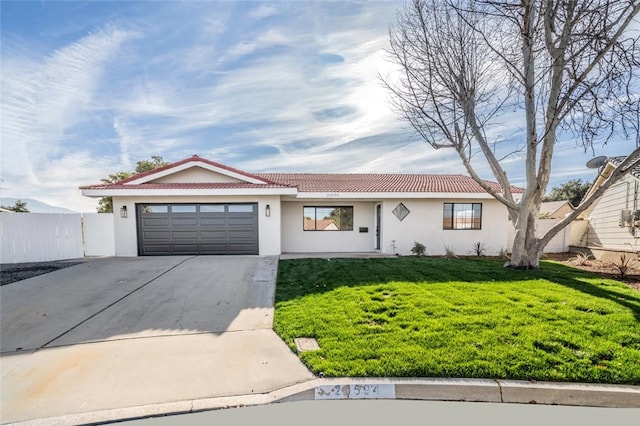 ranch-style home featuring concrete driveway, stucco siding, a tiled roof, an attached garage, and a front yard