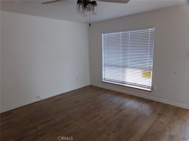 empty room with dark wood-style floors and ceiling fan