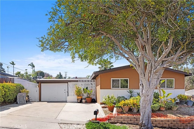 view of front of house with fence and stucco siding