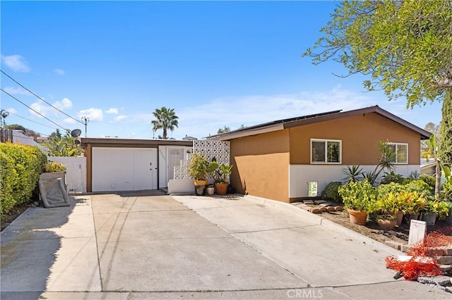 view of front facade featuring fence and stucco siding