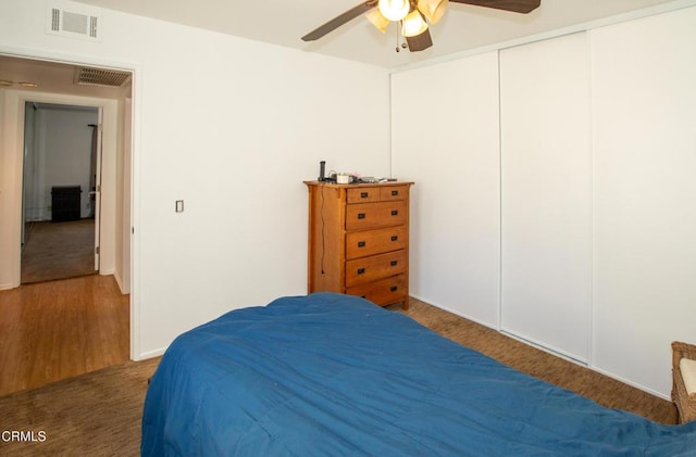 bedroom with a closet, visible vents, and a ceiling fan