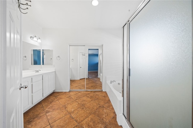 bathroom with a shower stall, vanity, and a bath