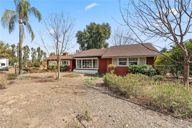 ranch-style home featuring fence