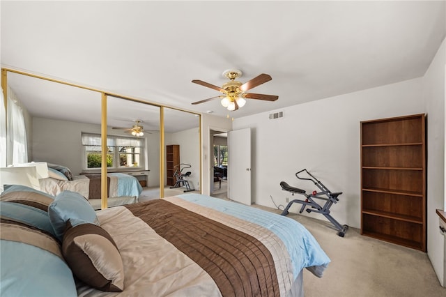 bedroom featuring a ceiling fan, light colored carpet, a closet, and visible vents