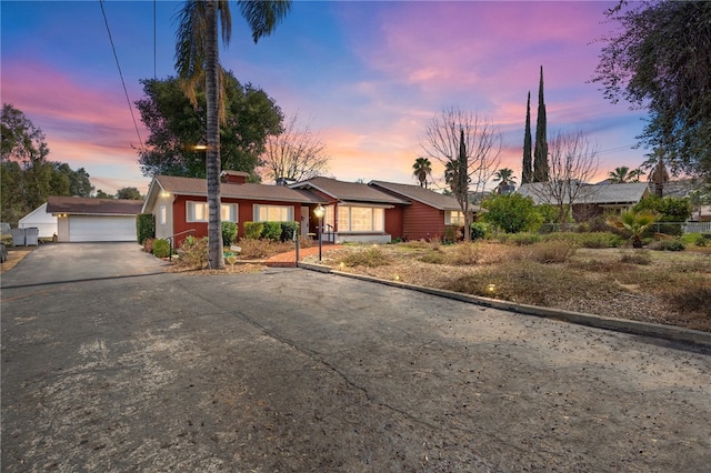 view of front of property featuring a garage and an outbuilding