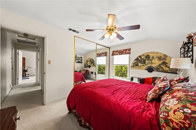 bedroom featuring a closet, visible vents, attic access, light carpet, and ceiling fan