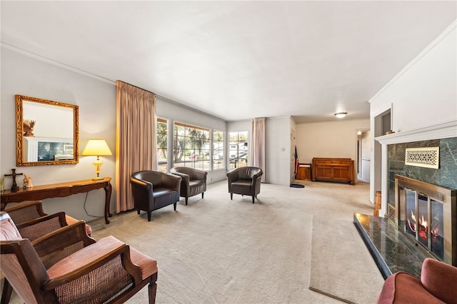 living area with crown molding, a premium fireplace, and light colored carpet