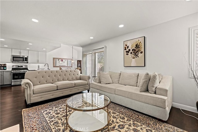 living area featuring baseboards, dark wood-style flooring, and recessed lighting