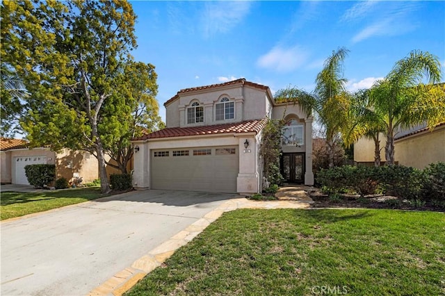 mediterranean / spanish house with concrete driveway, a tile roof, a front lawn, and stucco siding