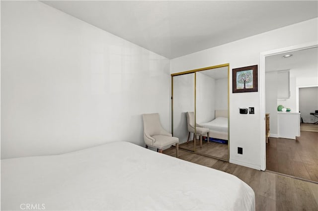 bedroom featuring a closet and wood finished floors