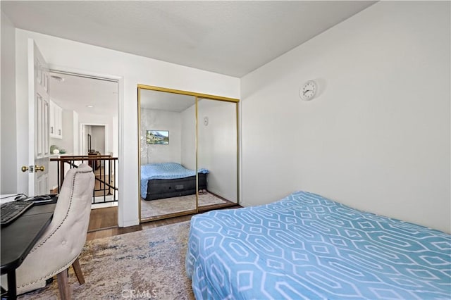 bedroom with a closet and wood finished floors