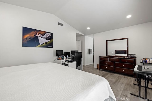 bedroom with lofted ceiling, visible vents, recessed lighting, and wood finished floors