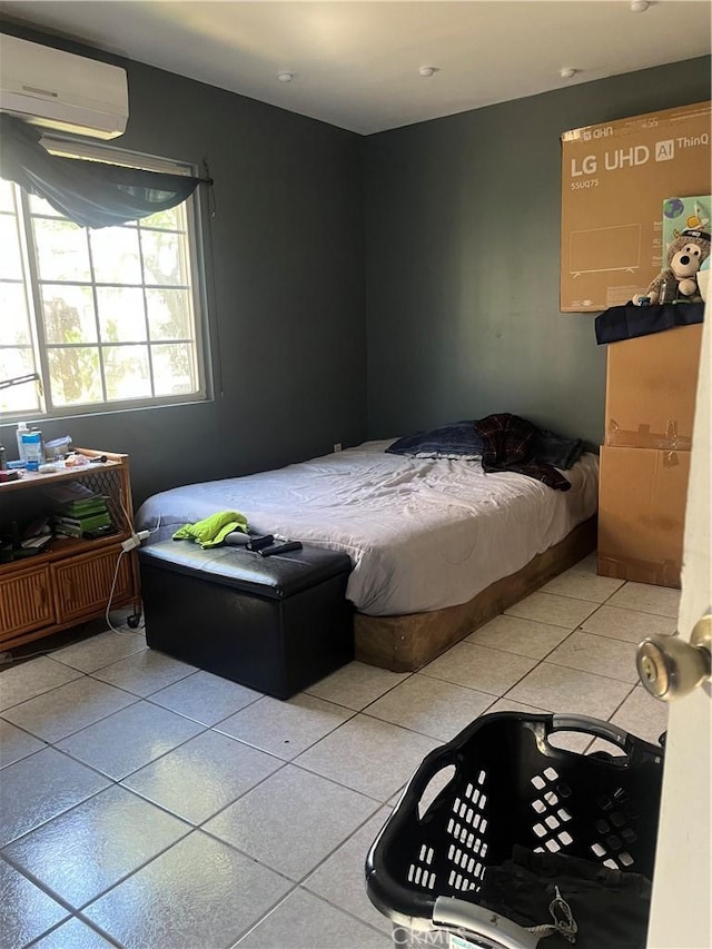 bedroom featuring light tile patterned floors and a wall mounted AC