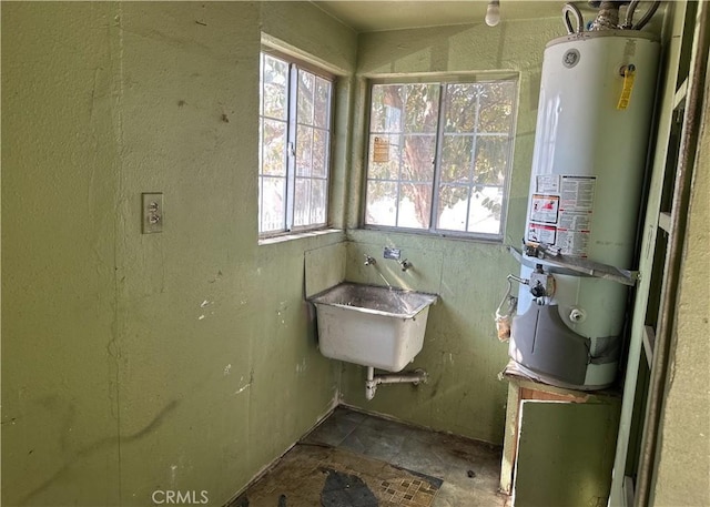 bathroom with gas water heater and a sink