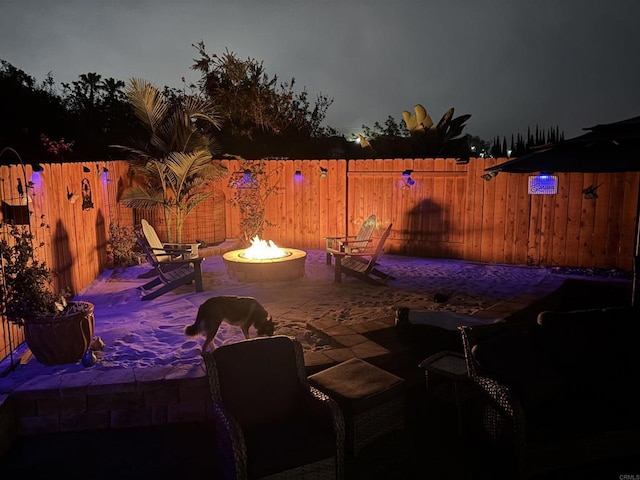 view of patio / terrace featuring an outdoor fire pit and a fenced backyard