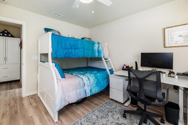 bedroom featuring ceiling fan, visible vents, and light wood-style floors