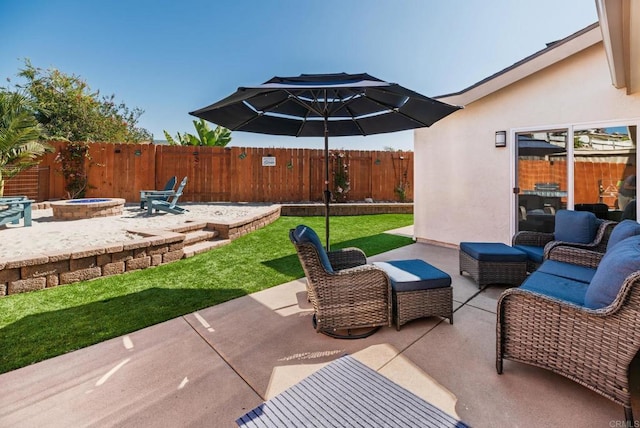 view of patio with a fenced backyard and an outdoor living space with a fire pit