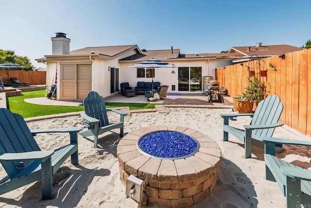 view of patio / terrace featuring fence and a fire pit