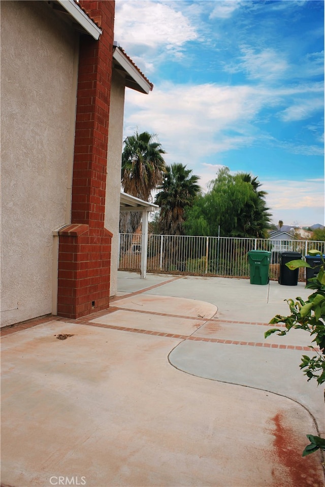 view of patio / terrace featuring fence