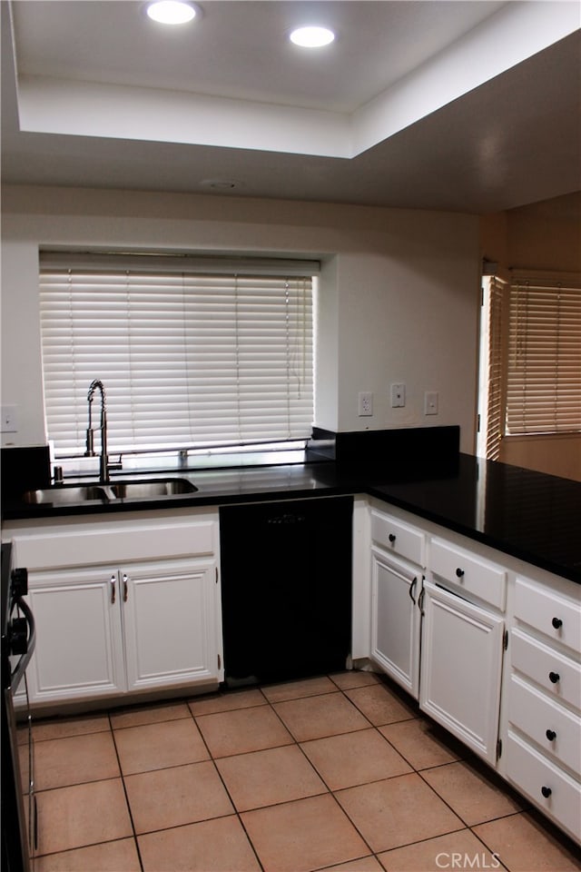 kitchen with a sink, white cabinetry, black dishwasher, stainless steel range, and dark countertops