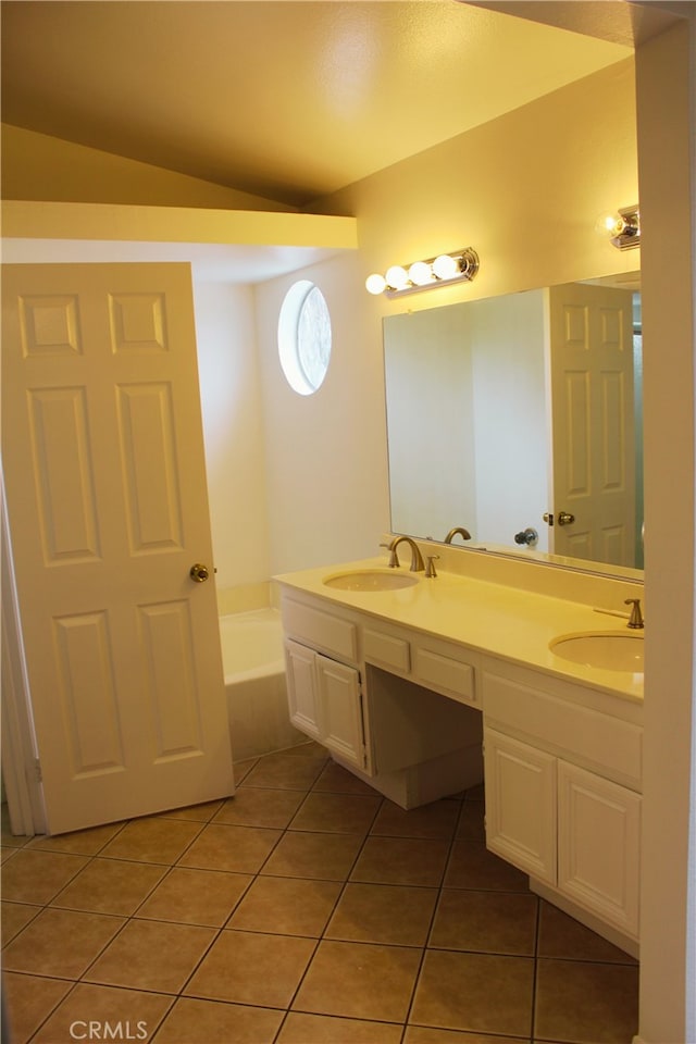 bathroom featuring double vanity, a garden tub, a sink, and tile patterned floors