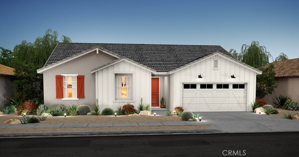 view of front of house featuring board and batten siding, concrete driveway, and a garage