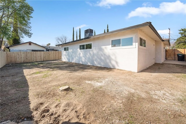 back of house with fence and stucco siding