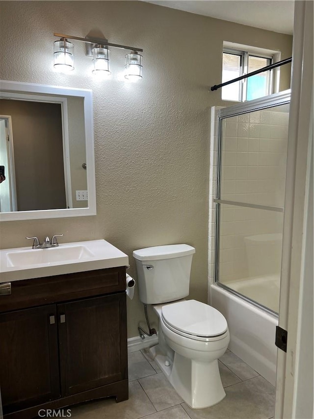 full bathroom featuring toilet, combined bath / shower with glass door, vanity, and tile patterned floors