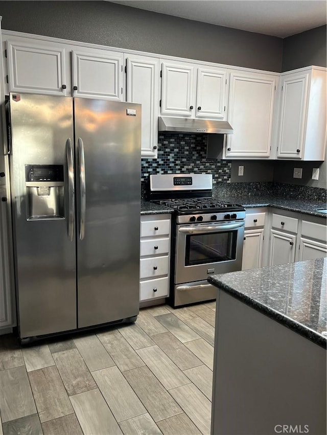 kitchen with stainless steel appliances, white cabinets, and under cabinet range hood