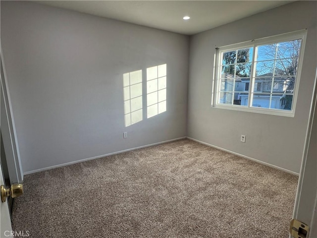 spare room featuring carpet floors, a healthy amount of sunlight, baseboards, and recessed lighting