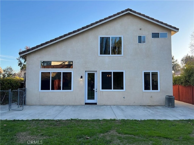 rear view of house featuring central AC, a patio area, fence, and stucco siding