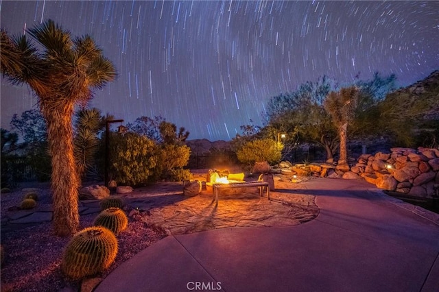 view of home's community with a fire pit and a patio