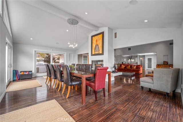 dining space featuring a chandelier, high vaulted ceiling, wood finished floors, and beam ceiling