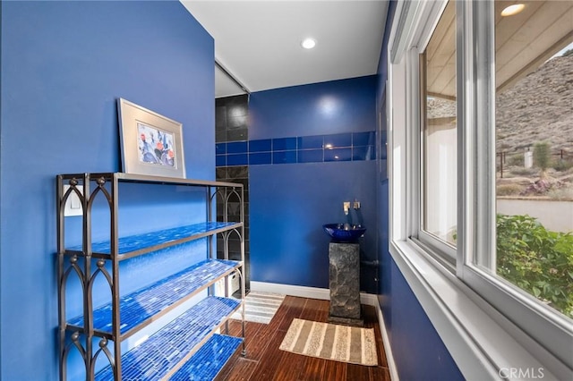 bathroom with recessed lighting, wood finished floors, and baseboards