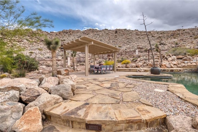 view of patio / terrace with an outdoor pool and a pergola