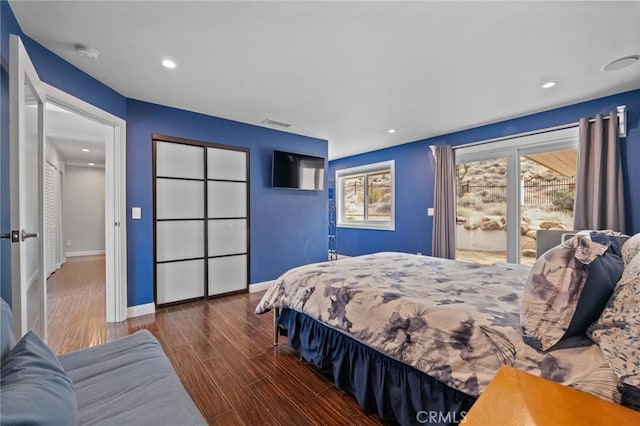 bedroom with recessed lighting, visible vents, baseboards, and wood finished floors