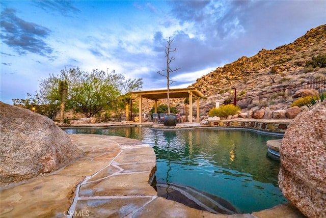 view of swimming pool featuring a patio area, fence, and a fenced in pool