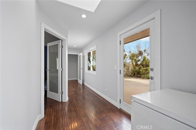 corridor featuring dark wood-style floors, baseboards, and recessed lighting