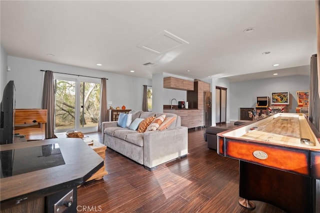 living area featuring attic access, recessed lighting, visible vents, and dark wood-style floors