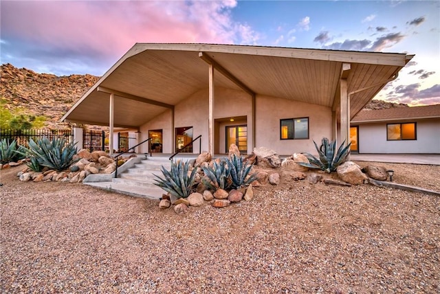 back of property with a patio area, fence, and stucco siding