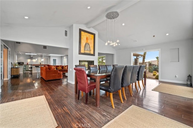 dining room featuring high vaulted ceiling, beam ceiling, baseboards, and wood finished floors